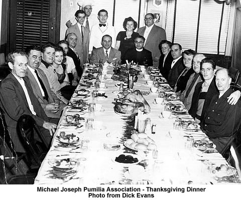 Thanksgiving Dinner
The Michael Joseph Pumilia Association was located on Bank Street just above High Street, Newark, New Jersey. They participated actively when any member of the community experienced a loss.  Fire, Job, Rent or Food  and Clothing assistance, Etc.
This is a picture of one of their many Thanksgiving Dinners. Mr. & Mrs. (Violet, Mike) Pumilia are standing next to Mack, the Chef and another member acted as server.
They sponsored an annual Christmas party at St Philip Neri Church and Mike Pumilia was Santa Claus as they gave out silver dollars and gifts to every child.
