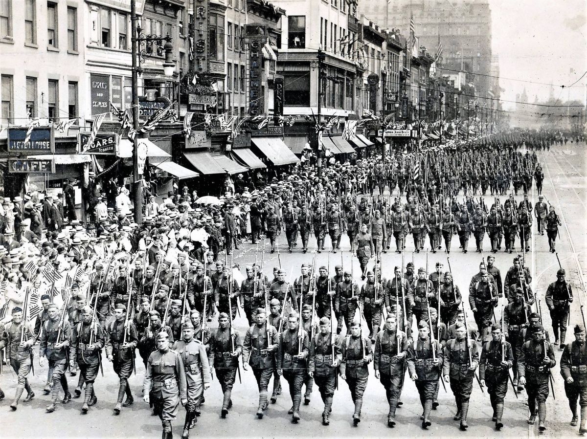 312th Infantry Returning
Here is the photo of the returning troops, from the 312th Infantry Regiment, marching in Newark in 1919. You can tell whether soldiers are coming or going by their hats. These men have the overseas cap, which means they are returning. Soldiers went overeseas with the wide brimmed campaign hat, which proved unusable overseas. These men are also carrying the US Model 1917 rifle, rather than the Model 1903 Springfield. The 1917, originally a British pattern, was manufactured in the US and converted to the US caliber ammunition when production of the 1903 could not keep up with demand.
Photo from Joe Bilby
